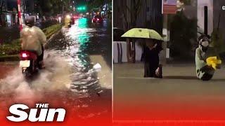 Tourists wade through floodwater as Vietnams Da Nang is battered by rain