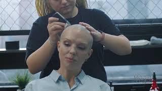 Lady does a full head shave in a classic barbershop. Trailer