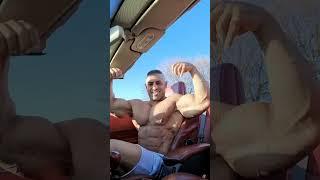 Bodybuilder flexing biceps in his car #bodybuilder #bodybuilding #muscle #biceps