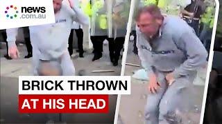 Violent protest sees UK man pelted with bricks