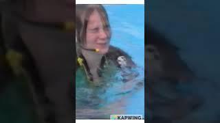 Girl dunking herself and speaking underwater in a shorty wetsuit