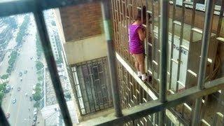 Chinese girl 5 rescued after she got her head stuck in bars OUTSIDE of apartments 24th floor.