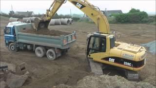 CAT 320C Excavator loading trucks