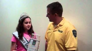 2011 NAMISS Iowa Pre-Teen Cover Girl Jordan George presents donations to Officer Rupiper