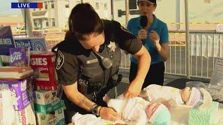 Champaign Police Officer steps up to the Diaper Challenge at WCIAs Diaper Drive 2024