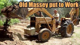 Backyard Overhaul with old MF-40 Backhoe - Grading removing trees and building a berm