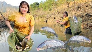 When the lake water receded the girl used a net to block the stream to block the fish.