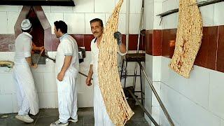 A huge traditional Iranian bread that is baked on pebbles  sangak bread  Iranian bakery