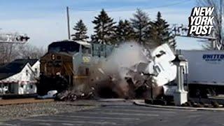 Oblivious driver stands feet away from tracks as speeding train plows through his truck