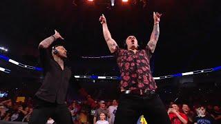 Happy Corbin and Corey Graves mock Pat McAfee by playing air guitar on the announce table