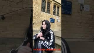 girl smoking and spitting on the stairs outside of her house at street