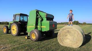 Working on the farm with tractors  Baling hay for kids  Round baler