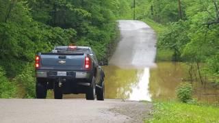 Mike driving through the water on the river road. Flood 2017