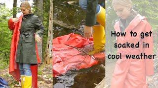 Blonde girl getting wet in layered raincaots and yellow wellies