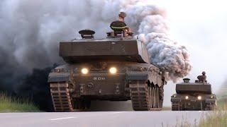 British Army tanks travel through German town  Big smoke cloud 