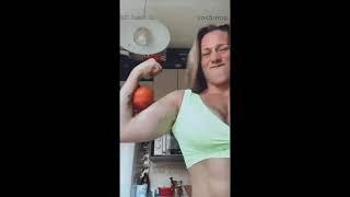 Female Bodybuilder crushing fruits from their biceps and hands