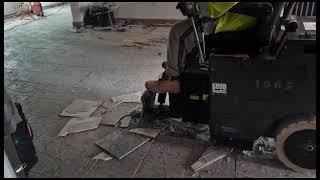 Removing ceramic flooring tiles with ease using the 5700 Ride On floor scraper.