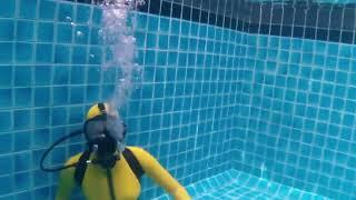 Female Diver is Diving with Latex Catsuit and SCUBA PRO Full Face Mask in Pool