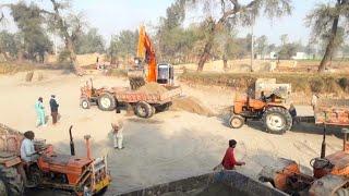 Excavator Machine Working With tractor  Traller loaded with Sand