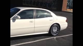 2003 Buick LeSabre sitting on 20 Divinity D18 Chrome wheels and 24535-20 Lexani tires.