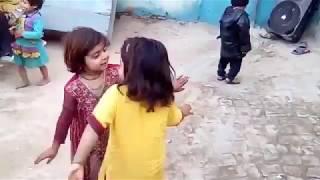 Two little girls dance