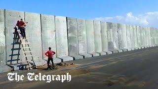 Egypt builds large cement wall at Gaza border for aid logistics zone officials say
