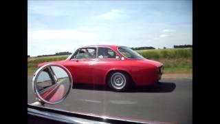 French farmers waving as we race to Le Mans Classic in two noisy red Alfa Romeos