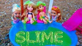 Elsa and Anna toddlers slime in the pool