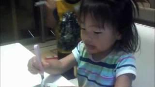 Little Japanese Girl Swallows a chunk of fish