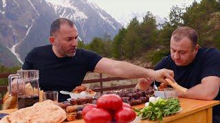 MEAT WITH VEGETABLES COOKED IN A POT ON OPEN FIRE