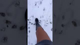 Demonstration of Black Leather Boots in the Snow