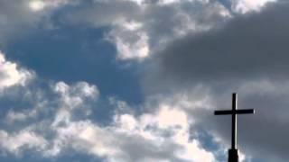 Jesus Face in the Clouds Praying by a Cross