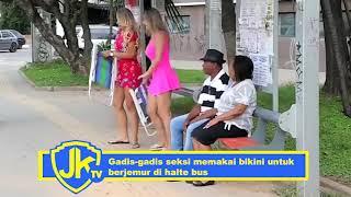 Sexy girls wear bikinis to sunbathe at bus stop