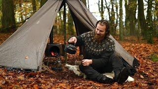 Bushcraft trip - rainy day in a hot tent next to large lake making firewood and cooking a meal etc.