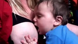 Young mom breastfeeding twin son