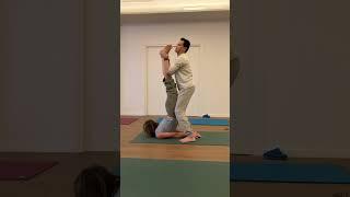 Yoga Teacher helps students practice folding their body