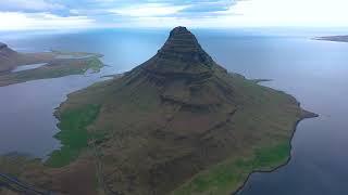 Flying over Kirkjufell mountain and the sea Snaefellsnes peninsula Iceland. 4k aerial drone view