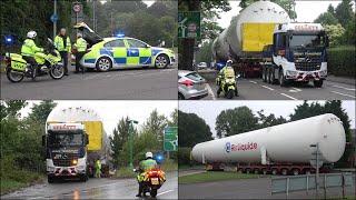 Police escort a large oxygen tanker through suburban streets