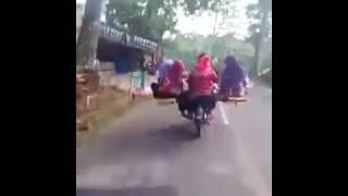 Muslim man takes his 4 wives along with his 4 kids on a motorcycle excursion