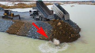 Regular Activities Continue Daily Build Road by Dozer komatsu pushing stone in water