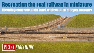 The realistic railway blending concrete plain track with wooden sleeper turnouts.