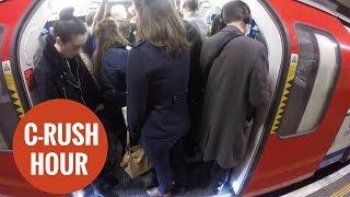 Commuters packed together on the London underground.