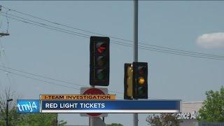 Police write red-light tickets at intersection with short yellow light