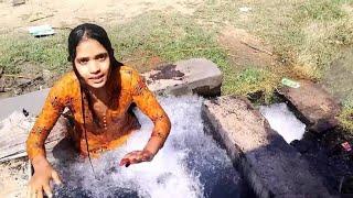 Swimming in tube well water pool in village