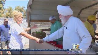 Sikh community members hand out hot lunch meals to homeless