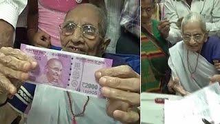 Watch  PM Modi’s mother exchanges money