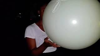 girl blows to pop Mellyloon balloon