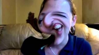 Girl laughing while making funny faces on distorted webcam