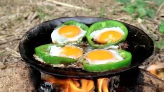 Survival skills Chicken eggs in peppers grilled on clay for food - Cooking eggs eating delicious