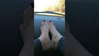 Wife shows off her feet in car